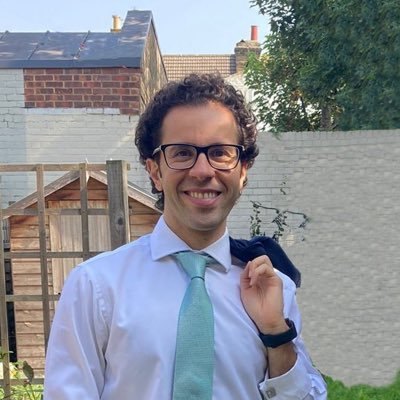 Alaa Al Khourdajie in a garden, a jacket over one shoulder